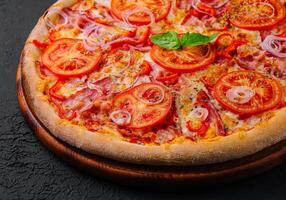 pizza with bacon onions and tomatoes photo