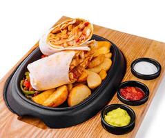 shawarma with fried potato wedges and different sauce photo