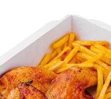 Fried chicken legs with french fries in paper box photo