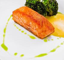 grilled salmon fillet steak with broccoli photo