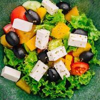 Greek salad with feta, avocado and black olives photo