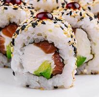 sushi rolls with raw tuna and avocado sprinkled with sesame photo