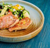 Grilled Red Snapper fish fillets and fresh vegetable salad photo