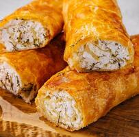 Cooking traditional pies with cottage cheese on wooden table photo