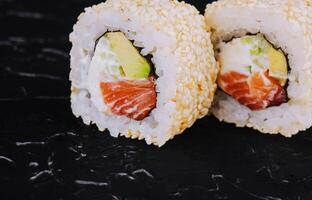 Japanese sushi rolls with salmon in rice and sesame photo