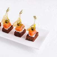 canapes with cheese and red fish photo