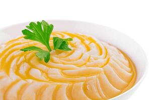 Bowl with mashed potatoes on white background photo