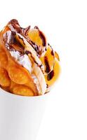 hong kong or bubble waffle with whipped cream, chocolate and bananas photo