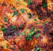 roasted chicken Piri Piri with parsley photo