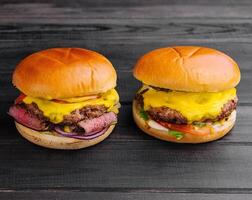 Tasty burgers on wooden table top view photo