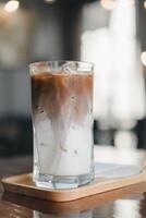 Cold mocha in glass. Beautiful texture and layers fresh milk and coffee in glass. photo