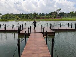 Man stand in front of the way lake on down town. The photo is suitable to use for adventure content media, nature poster and forest background.