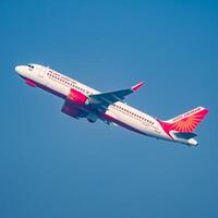 New Delhi, India, December 25 2023 - Air India Airbus A320 take off from Indra Gandhi International Airport Delhi, Air India domestic aeroplane flying in the blue sky during day time photo