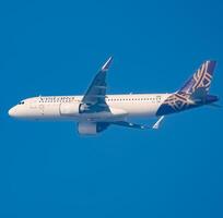 New Delhi, India, December 25 2023 - Vistara Airbus A320 neo take off from Indra Gandhi International Airport Delhi, Vistara domestic aeroplane flying in the blue sky during day time photo