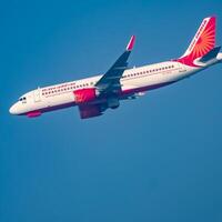 New Delhi, India, December 25 2023 - Air India Airbus A320 take off from Indra Gandhi International Airport Delhi, Air India domestic aeroplane flying in the blue sky during day time photo