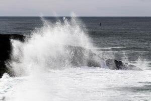 Wave Splashing Against Lava Rock Depoe Bay Oregon photo