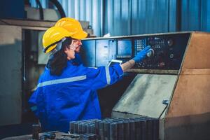 Portrait of Heavy industry workers working on the metal fabrication process by operating a lathe at a machine for steel structure industry. photo