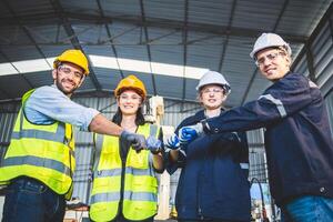 Engineers team mechanic standing in steel factory workshop. Industry robot programming software for automated manufacturing technology photo