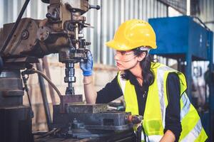 Portrait of Heavy industry workers working on the metal fabrication process by operating a lathe at a machine for steel structure industry. photo