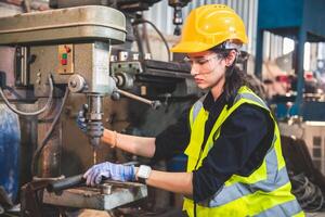 Portrait of Heavy industry workers working on the metal fabrication process by operating a drilling at a machine for steel structure industry. photo