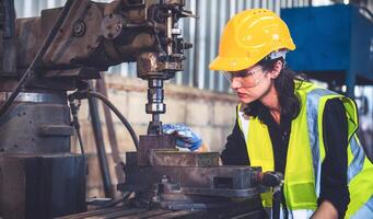 Portrait of Heavy industry workers working on the metal fabrication process by operating a lathe at a machine for steel structure industry. photo