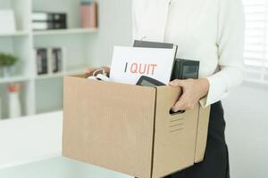 resignation, leave, quit, Stressful businesswomen will resign from the company. Female staff is lifting a brown paper box that holds personal items. , job placement and vacancies, resignation letter photo