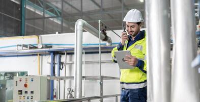 Mechanic or maintenance or electrical engineer checking main electrical control systems industrial plant. Utility fore man daily check power systems in process. Main Distribution Board, Switchboards photo