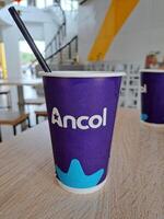 jakarta indonesia january 31th 2024 purple cola and tea drinking cups that say in the ancol recreation park photo
