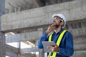 Caucasian engineer in full safety gear is inspecting the crack and leaking spot inside the building structure for investigation over specification and quality control usage photo