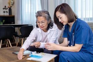 Senior woman get medical service visit from caregiver nurse at home while explaining on doses of vitamins and drug pill for health care and pension welfare insurance photo