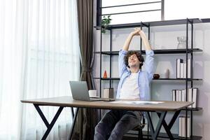 Caucasian man freelancer is having relieve with his successful job while working at home  about online task for accountant, auditor, programer and broker occupation photo