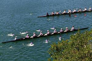 Folsom, CA, 2011 - Two Boats Of Women's Crew Teams On The Water Practicing photo