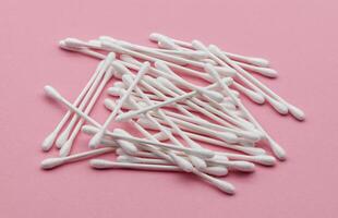 Cotton sticks swab isolated on pink background photo