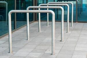 metal poles are lined up on a sidewalk photo