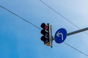 a traffic light with red with a view from below photo