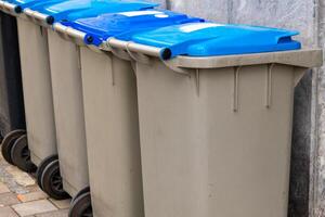 different trash cans on a sidewalk photo