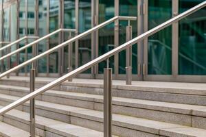 a staircase with a railing and a glass door photo