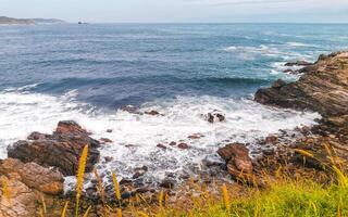 Punta Playa Cometa sunset panorama view mountains rocks Mazunte Mexico. photo