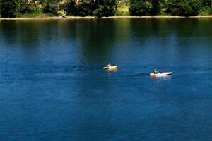 Folsom, CA, 2010 - Two Yellow Kayaks On River photo