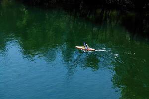 Folsom, CA, 2010 - Lone Kayak On River Seen From Above photo