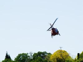 Folsom, CA, 2009 - Red And White Rescue Helicopter Flying Over Trees photo