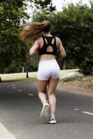 Caucasian Teen Girl Running On Bike Path photo