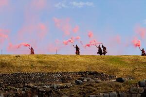 Cusco, Peru, 2015 - Men In Traditional Costume Releasing Red Smoke Inti Raymi photo