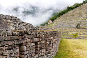 Machu Picchu, Peru, 2015 - Stone Wall Detail Machu Picchu With Tourists In Background photo