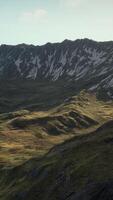 A view of a mountain range from the top of a hill video