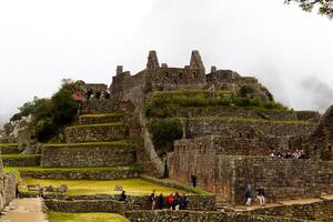 Machu Picchu, Peru, 2015 - Groups Of Tourist Exploring Machu Picchu Ruins Peru photo