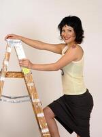 Hispanic Woman In Black Skirt And Yellow Top With Ladder photo