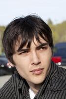 Young teen man outdoor portrait piercing lip photo