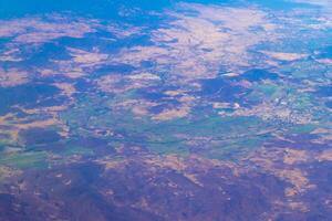 Flying airplane over Mexico Clouds Sky Volcanoes Mountains City desert. photo