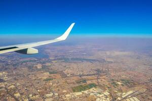 Flying airplane over Mexico Clouds Sky Volcanoes Mountains City desert. photo